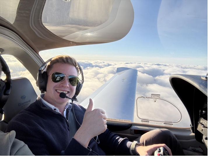 The founder of ATPL Games in the cockpit above the clouds